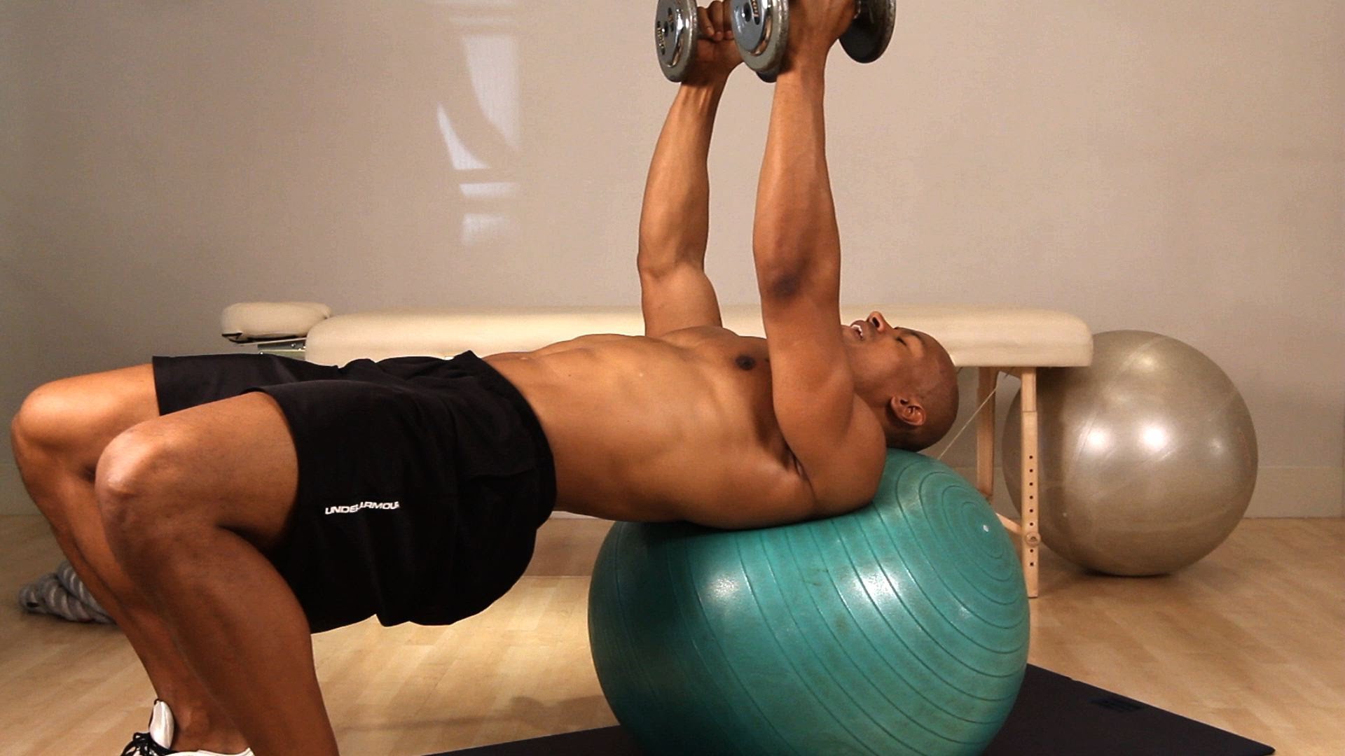 press of dumbbells on fitball
